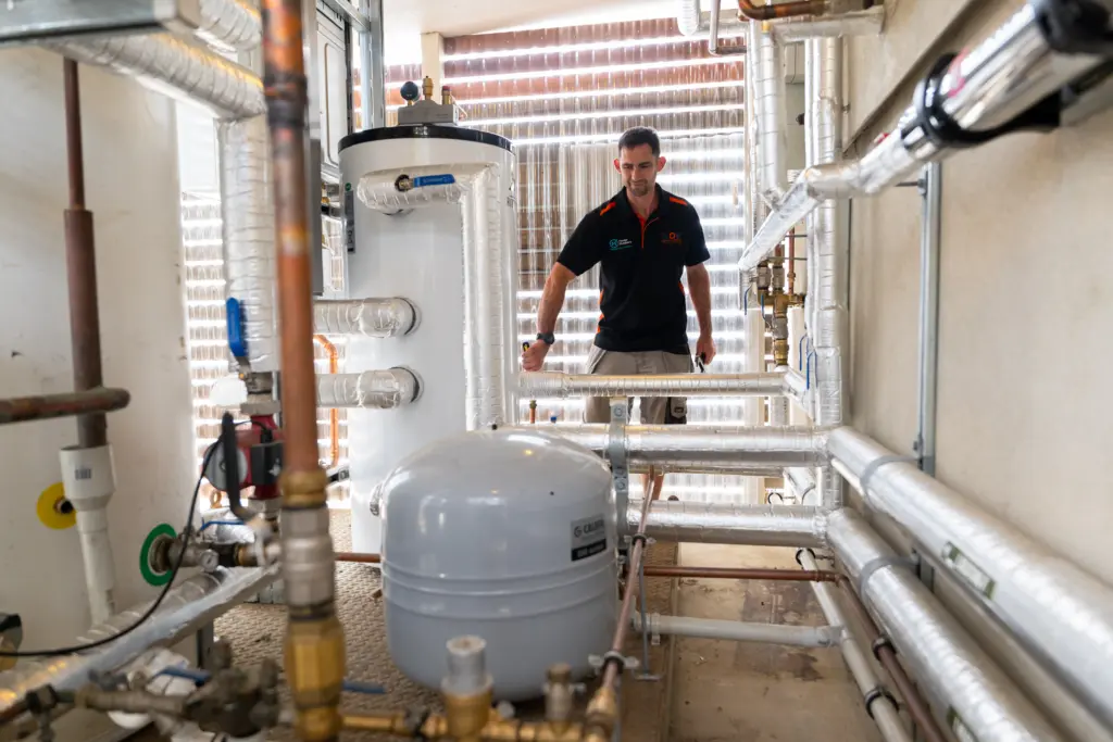 Hot water cylinder and pipework in a commercial plant room
