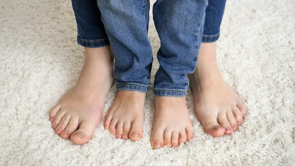 Bare feet on carpet in a room kept warm by underfloor heating