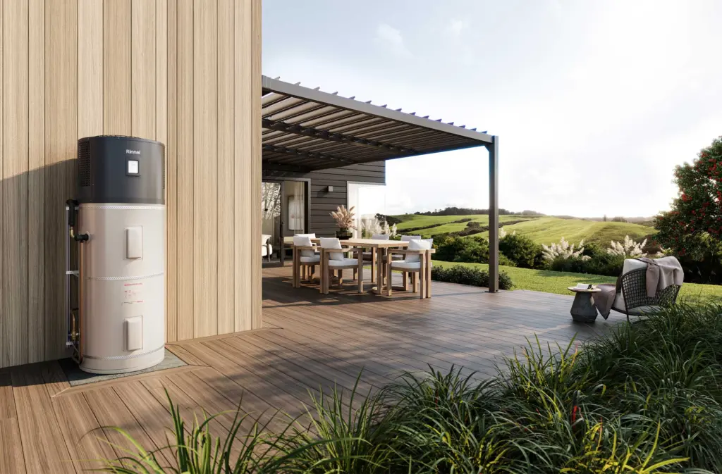 Hot water heat pump cylinder installed outside a modern home
